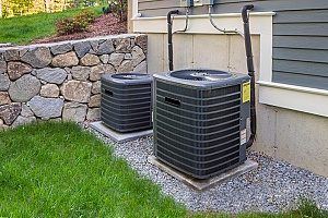 two air conditioning units that have cover from the roof of the house and therefore will not be affected by snow