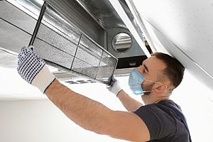 man cleaning the filter