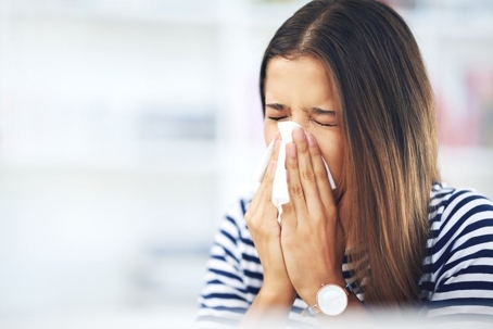 a woman sneezing