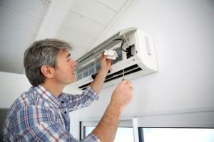 A man cleaning AC