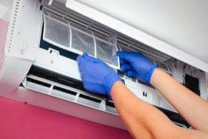 A technician fixing the AC unit