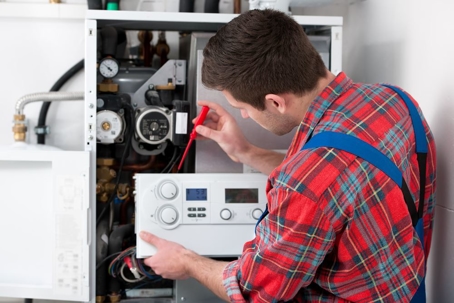 A man working on a heating unit