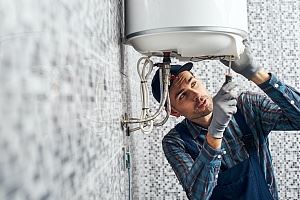 A technician fixing a water heater