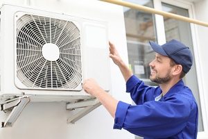 person installing a split system air conditioner