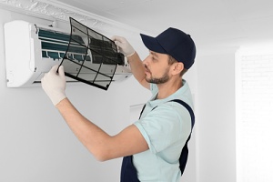 a man learning to check the freon in a home air conditioner