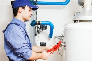 qualified HVAC contractor surveying a furnace to make sure it does not need repairs