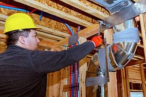 an HVAC contractor working on ductwork installation
