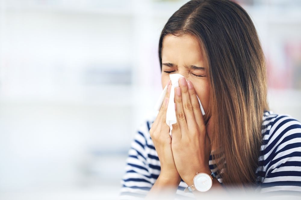 a woman sneezing