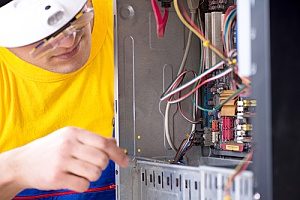 a furnace replacement contractor going in and inspecting the new furnace he installed for a homeowner