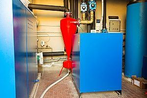 a geothermal heat pump in a boiler room of a home that was recently serviced by Maryland HVAC contractors for the purpose of installing a new heating system for the winter