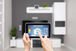 A tablet is held, showing a home control interface.
