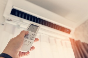 person using air conditioning system in home