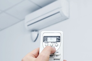 man using air conditioning after installing it for the summer