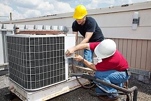 2 men repairing airconditioner