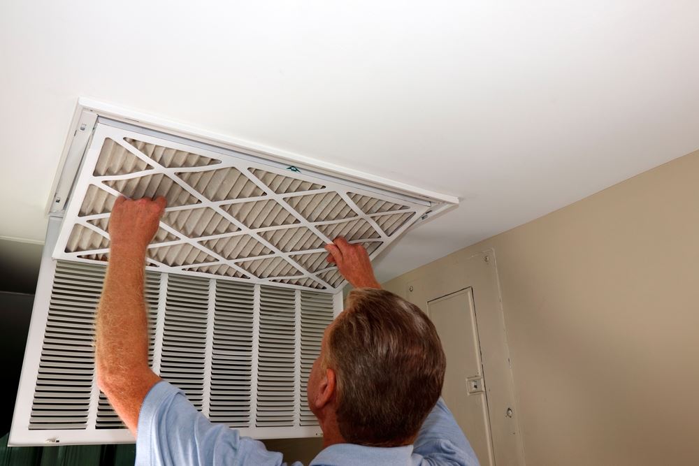 A guy changing the air filter