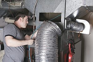 a man cleaning mold out of his ductwork with the help of an HVAC contractor