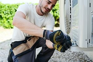 A technician fixing the AC