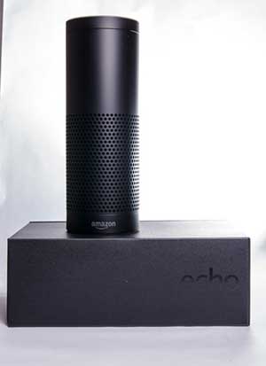A black Amazon Echo speaker on a black box.