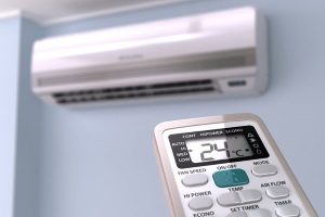remote controlling a ductless mini-split air conditioner that is hanging on the wall