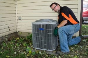 HVAC contractor performing routine HVAC maintenance and repairs