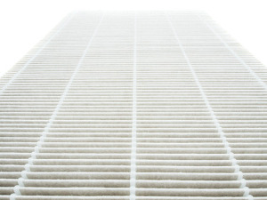 A close-up of a white air filter with a grid pattern.