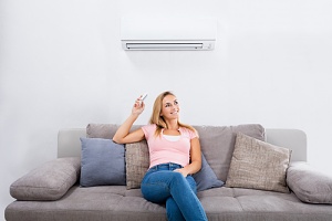 woman receiving the benefits of installing air conditioning in the summer