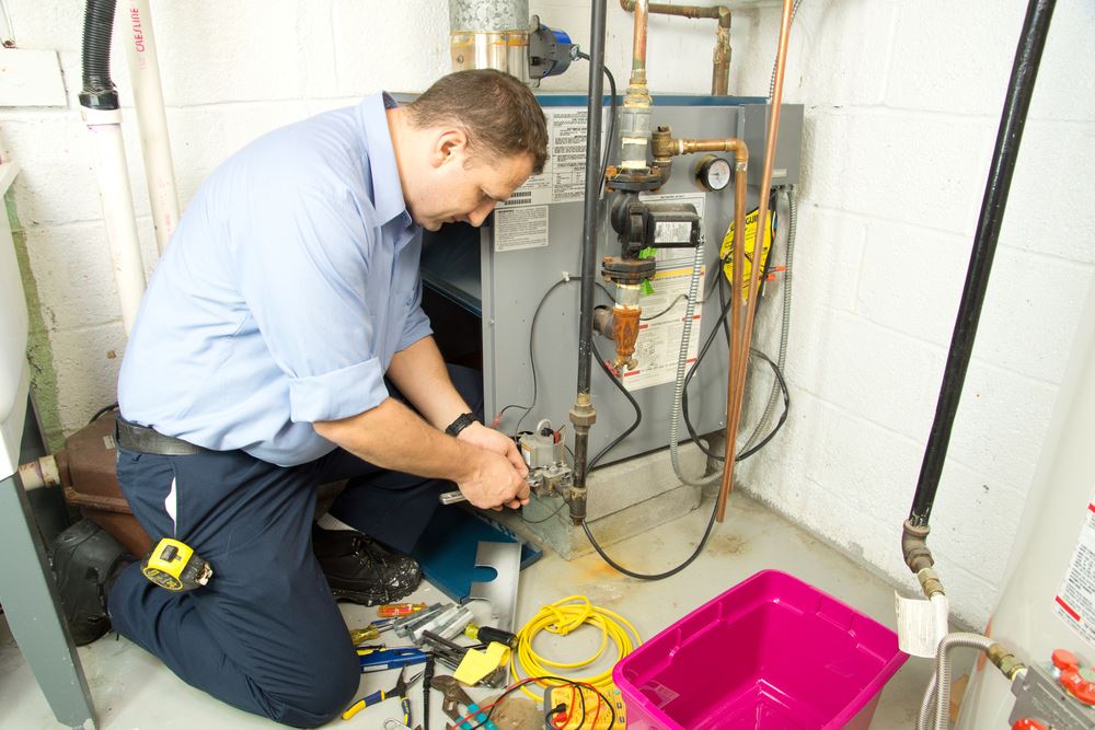 technician repairing the heating system