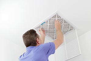 professional HVAC Contractor performing an extensive air duct cleaning