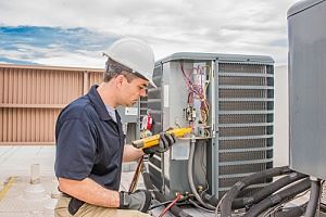 HVAC technician working on unit