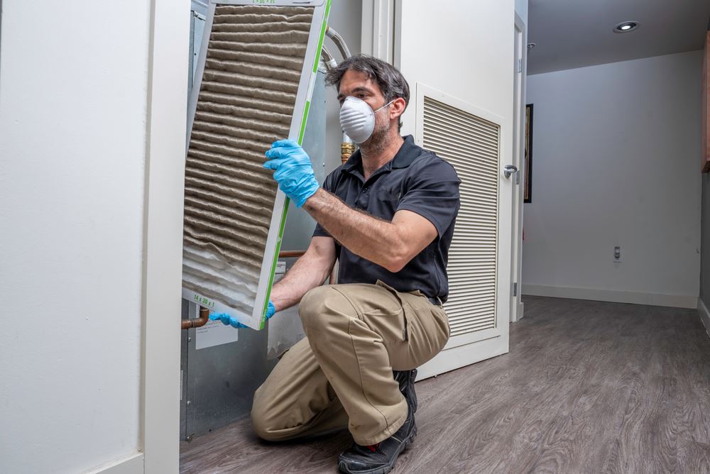 A technician fixing the HVAC