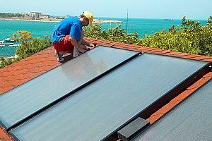 solar panels being installed on a roof as an internal heating system for the house