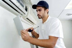 HVAC contractor working on installing a brand new air conditioning system for a resident in Maryland