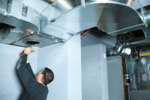 A NATE certified HVAC contractor properly checking the ventilation system for dust in a home in Silver Spring, MD