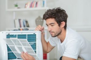 Gaithersburg, MD HVAC contractors working on a dehumidifier installation