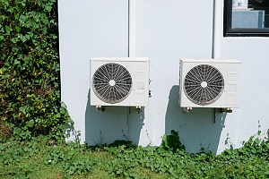 commercial HVAC compressors helping to cool a building