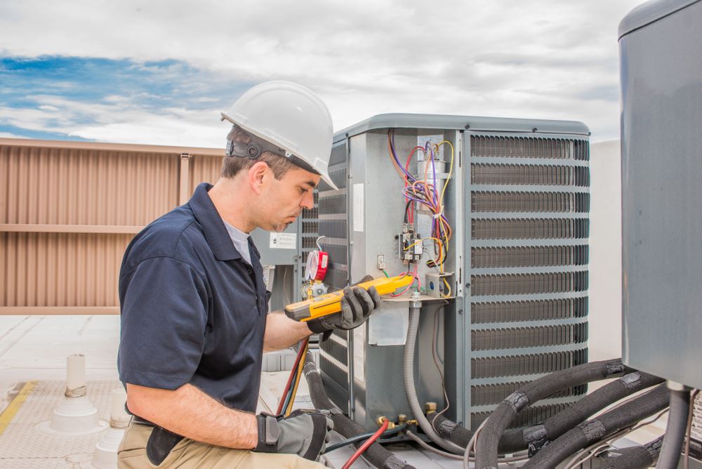 A technician repairing the HVAC unit