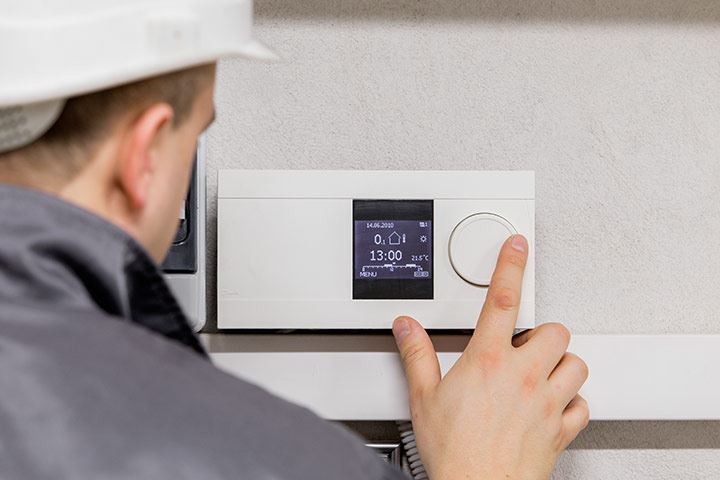 A technician tuning a furnace controller