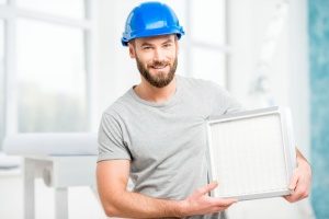 an HVAC maintenance contractor ready to replace an HVAC filter