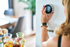 woman adjusting programmable thermostat