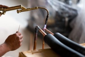 welding of a copper pipe, commonly done by HVAC contractors, during an HVAC repair