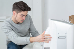 a man configuring the settings on a dehumidifier