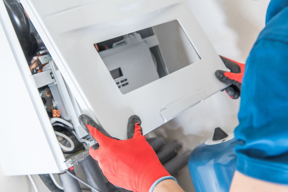 A man checking the furnace